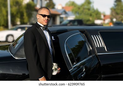 Young Afro American Man In Tuxedo Standing By Limousine Going To Prom