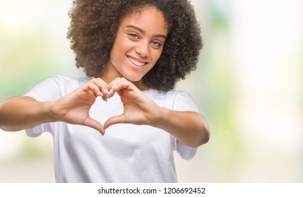 Young afro american woman over isolated background smiling in love showing heart symbol and shape with hands. Romantic concept. - Shutterstock ID 1206692452