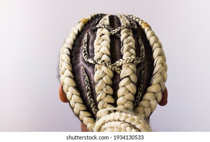 Young afro with blonde Boxer braids, African hair style also known as "Kanekalon braids." Close up on decoration and style.