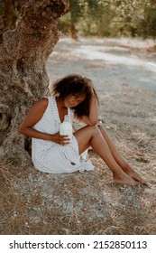 Young Afro Girl On Safari Nature Drink Milk In Sundress And Hat. Afro Hair, Ecology, Health, Milk Bottle, Brunette, Afro Hair, Relaxation, Tranquility, Farm Products