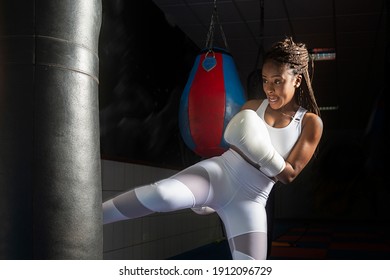 Young afro girl training kickboxing inside the gym, strength, inspiration, determination. - Powered by Shutterstock