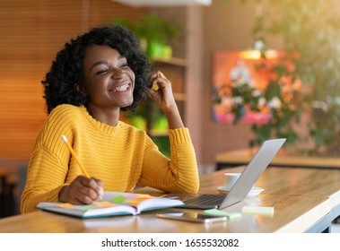 Young Afro Woman Dreaming About Successful Career, Looking For Job Online, Using Laptop, Empty Space