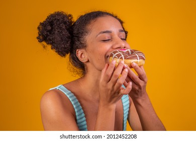 Young Afro Woman Eating Delicious Chocolate Donuts.