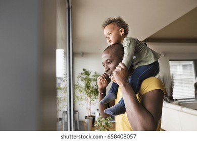 Young afro-american father with his little daughter at home. - Powered by Shutterstock