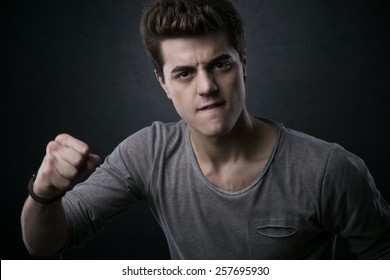 Young Aggressive Man Showing Fists And Looking At Camera