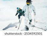 A young aggressive skier on an alpine slope demonstrates an extreme carving skiing style. He is skiing on morning perfectly groomed piste.