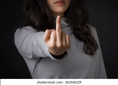 Young aggressive woman showing middle finger.