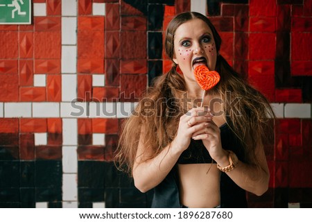 Young agressive clown girl with sweet