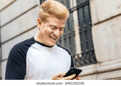 Young Albino latin man walking down the street using smartphone - Powered by Shutterstock