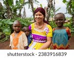 Young albino mother sitting in her yard with her three children. Motherhood concept.