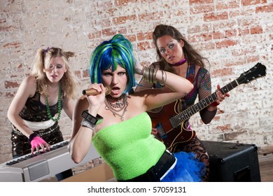 Young All Girl Punk Rock Band Performs In Front Of Brick Wall