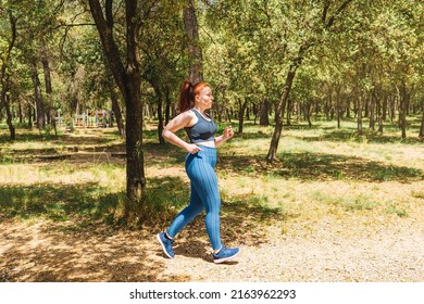 Young Amateur Athlete, Jogging In A Public Park To Keep His Body Healthy. Athlete Practising Sport Outdoors. Health And Wellness Lifestyle.