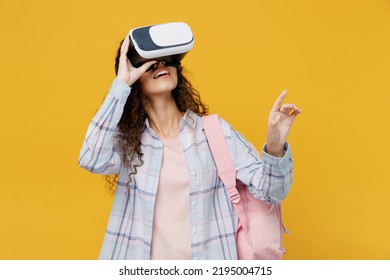 Young Amazed Happy Fun Black Teen Girl Student She Wear Casual Clothes Backpack Bag Watching In Vr Headset Pc Gadget Isolated On Plain Yellow Color Background. High School University College Concept