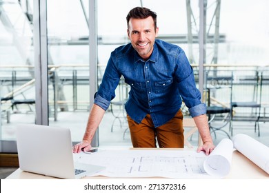 Young Ambitious Architect Presenting The Blueprint Of A New House