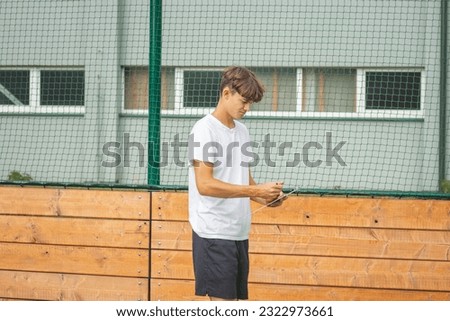 Similar – Image, Stock Photo Young, ambitious coach instructs his players on what to do on the field. Coaching games from behind the line. Mentality and crisis preparedness