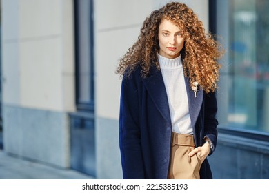 Young Ambitious Woman In Wool Coat Walking On The Street