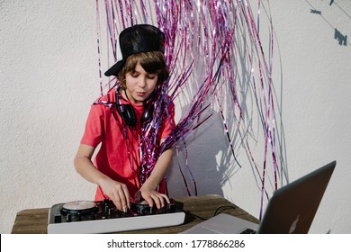 A young American boy near the DJ controller - the concept of DJing