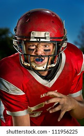 Young American Football Player In The Ready Stance.