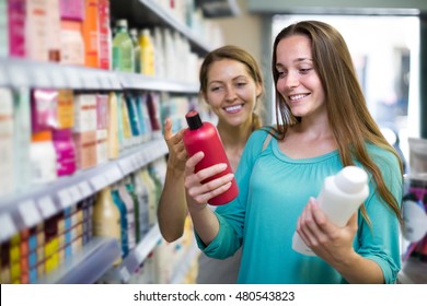 Young American Girl Buying Shampoo In Shopping Mall
