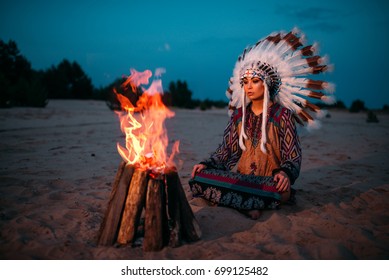 Young American Indian woman against fire - Powered by Shutterstock