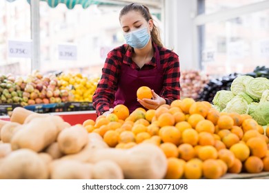 Young American Woman Shopping Assistant In Face Mask Holding Oranges At Grocery Shop