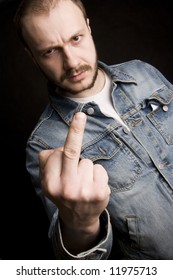 Young Angry Man Giving The Middle Finger (black Background)