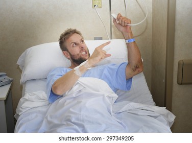 Young Angry Patient Man At Hospital Room Lying In Bed Pressing Nurse Call Button Feeling Nervous And Upset In Some Kind Of Emergency Health Care And Medical Attention Concept