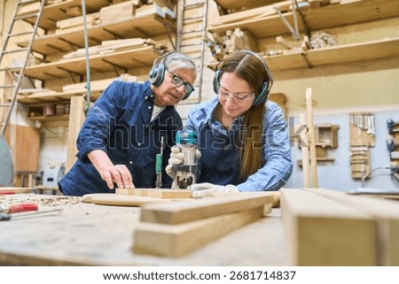 A young apprentice learns woodworking from an experienced mentor in a lumberyard. The image highlights the concepts of training, teamwork, and craftsmanship as they work together on a project.