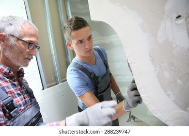  Young Apprentice With Professional Plasterer