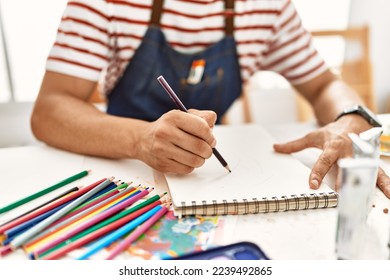 Young arab artist man smiling happy drawing at art studio. - Powered by Shutterstock