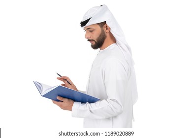 young Arab businessman standing and writing in folder, book,notebook on a white background. business concept, teacher. 