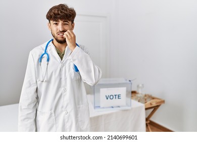 Young Arab Doctor Man At Political Election By Ballot Looking Stressed And Nervous With Hands On Mouth Biting Nails. Anxiety Problem. 