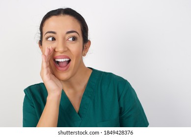 Young Arab Doctor Surgeon Woman Over Isolated White Background Hear Incredible Private News Impressed Scream Share