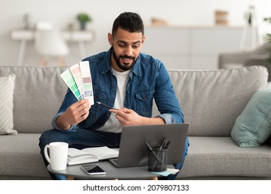 Young Arab Guy Showing Color Swatches At Laptop Screen At Home Office, Presenting Graphic Design Project On Remote Meeting. Millennial Middle Eastern Designer Selecting Gamma For Future House Interior