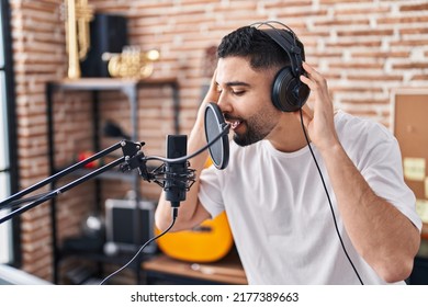 Young arab man artist singing song at music studio - Powered by Shutterstock