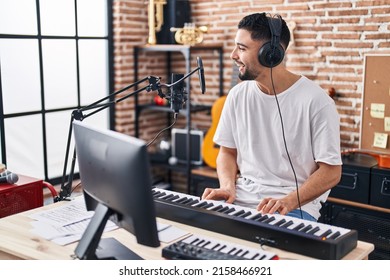 Young arab man musician playing piano keyboard at music studio - Shutterstock ID 2158466921