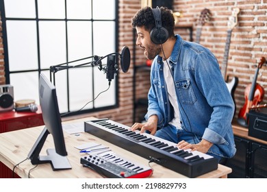 Young Arab Man Musician Singing Song Playing Piano Keyboard At Music Studio