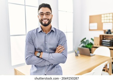 Young arab man smiling confident standing with arms crossed gesture at office