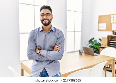 Young arab man smiling confident standing with arms crossed gesture at office - Shutterstock ID 2177389665