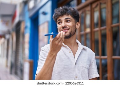 Young arab man smiling confident talking on the smartphone at street - Shutterstock ID 2205626311