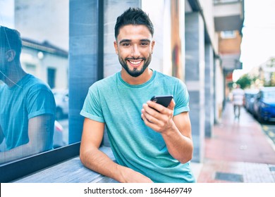 Young Arab Man Smiling Happy Using Smartphone At The City.