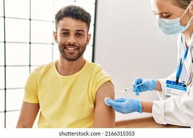 Young Arab Man Smiling Happy Waiting For Covid-19 Vaccine At Hospital.