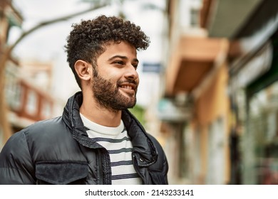 Young arab man smiling outdoor at the town - Powered by Shutterstock
