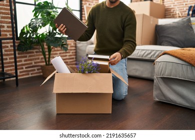 Young Arab Man Unboxing Books At New Home