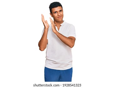 Young Arab Man Wearing Casual Clothes Clapping And Applauding Happy And Joyful, Smiling Proud Hands Together 