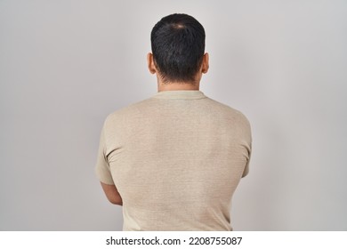 Young Arab Man Wearing Casual T Shirt Standing Backwards Looking Away With Crossed Arms 