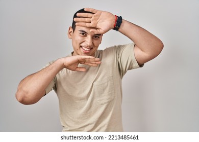 Young Arab Man Wearing Casual T Shirt Smiling Cheerful Playing Peek A Boo With Hands Showing Face. Surprised And Exited 