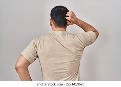 Young Arab Man Wearing Casual T Shirt Backwards Thinking About Doubt With Hand On Head 