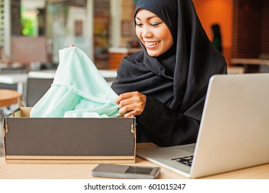 Young Arab Smiling Woman Getting Delivery Of Her Online Shopping Order