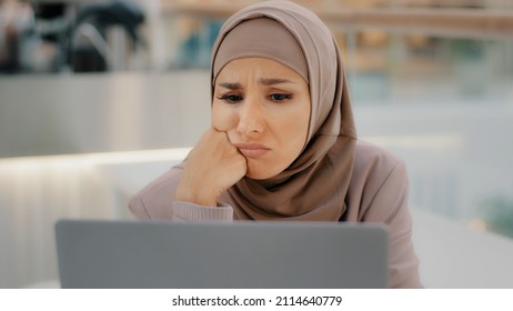 Young Arab Sorrowful Woman In Hijab Reading Message On Laptop Gets Bad News Denied Bank Loan Job Dismissal Bankruptcy Failing Exam Girl Upset From Unexpected Information Makes Funny Sad Expression